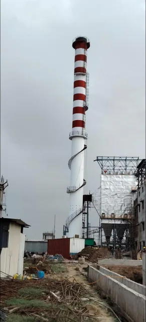 RCC chimney with an external stair beside industrial plant structures.