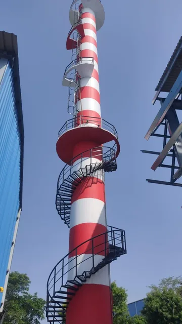 Close view of the spiral stair and access platforms on a red-and-white RCC chimney.