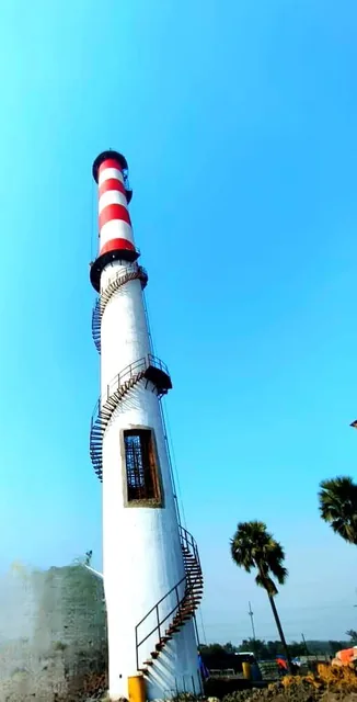 White RCC chimney with a spiral access stair and red-and-white upper bands.