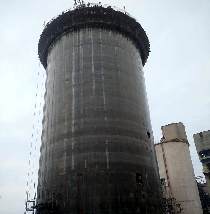 Concrete silo shell with scaffolding and construction work at the top, pictured in the BrajProjects brochure.